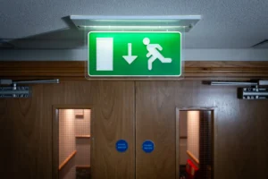 Emergency exit light in front of a fire exit.